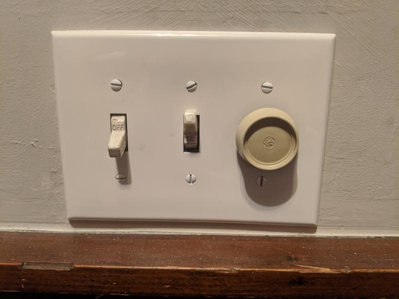 Two light switches and a dimmer